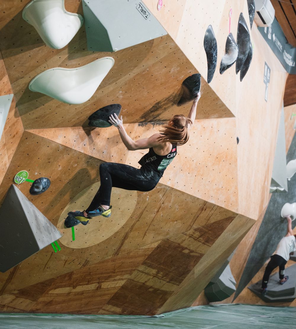 A climber jumping for some holds at a climbing competition