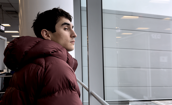 A man looking at the camera in an airport