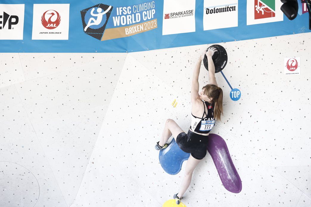 Madison Fischer tops a boulder at the Brixen Boulder World Cup