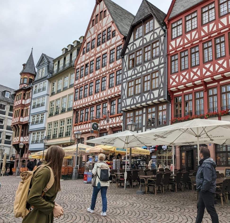 A woman looking at historic buildings in Frankfurt, Germany's old town